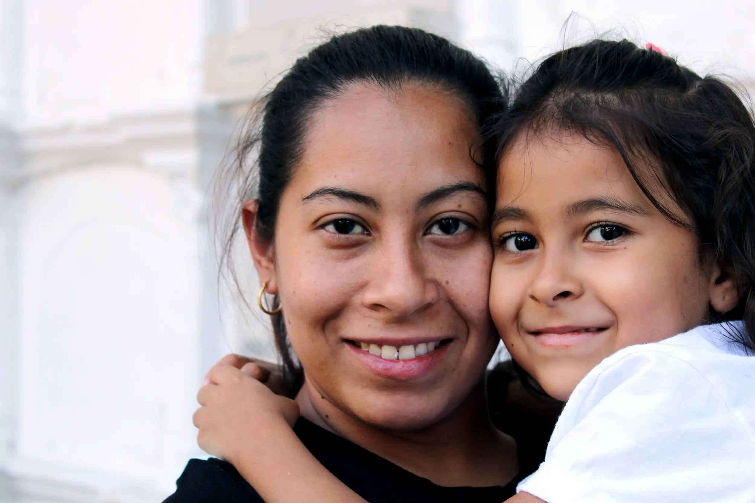 Immigrant mother and daughter smiling