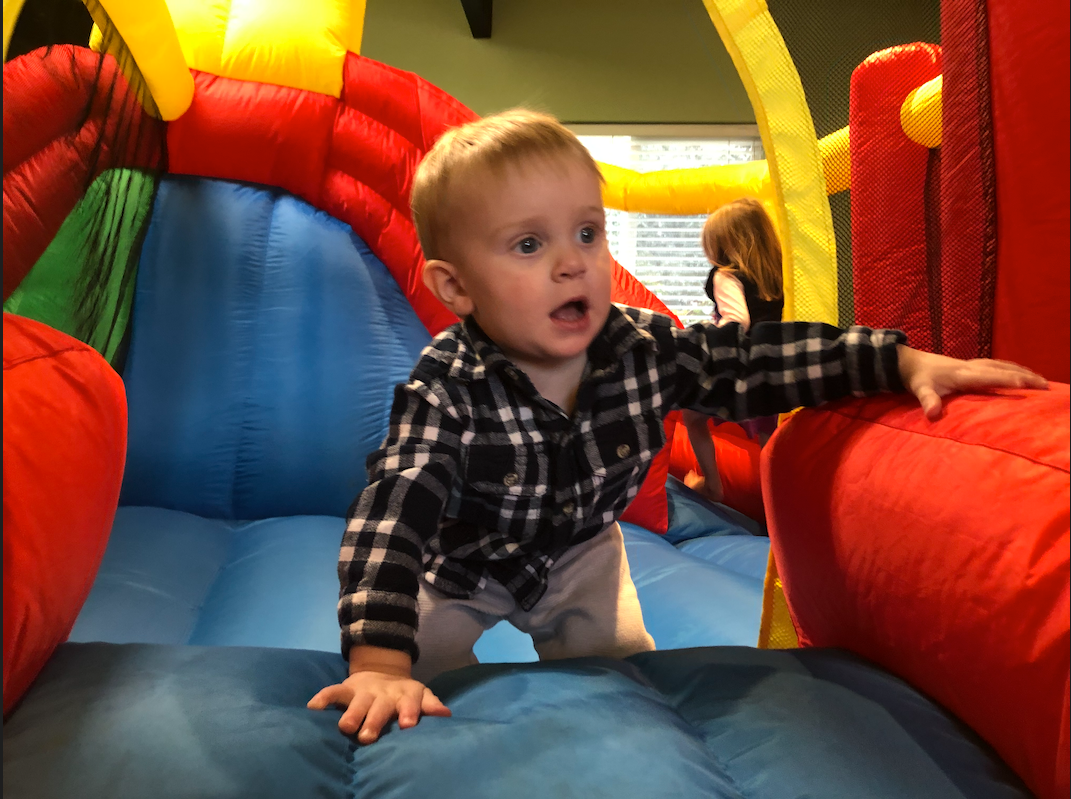 A young toddler in a small bounce house