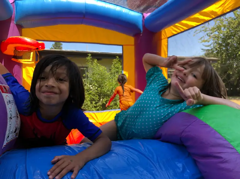Smiling kids on a bounce house